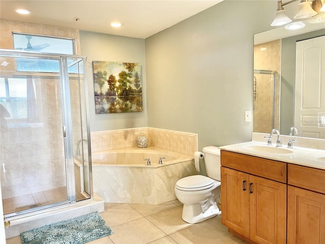 bathroom with vanity, a shower stall, a garden tub, and tile patterned floors