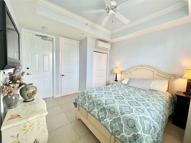 bedroom featuring a ceiling fan, light tile patterned flooring, ornamental molding, an AC wall unit, and a raised ceiling