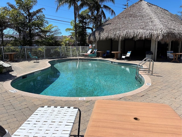 pool with a patio area, a gazebo, and fence