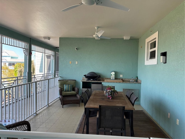 interior space featuring outdoor dining area, a balcony, and ceiling fan