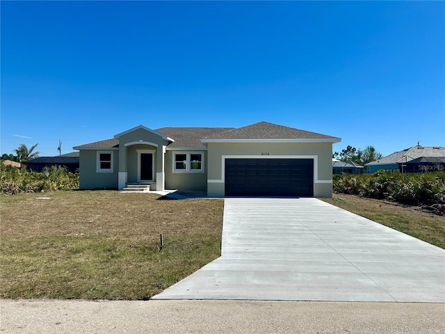 view of front of property with a garage, concrete driveway, roof with shingles, a front lawn, and stucco siding