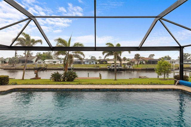 view of swimming pool featuring a residential view, a water view, a lawn, and a lanai