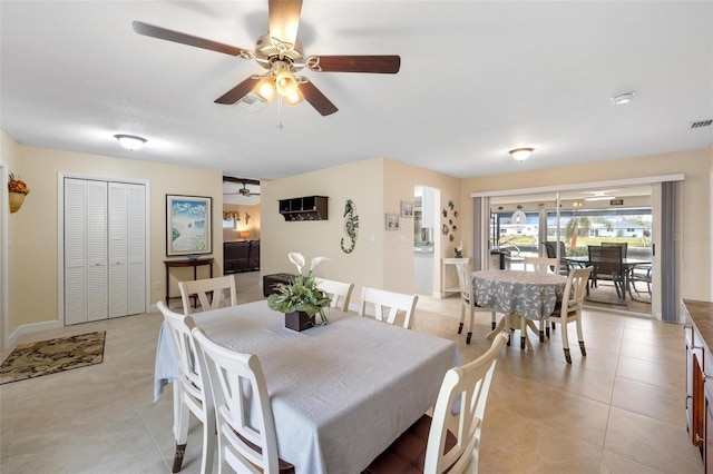 dining area featuring light tile patterned floors, visible vents, and ceiling fan