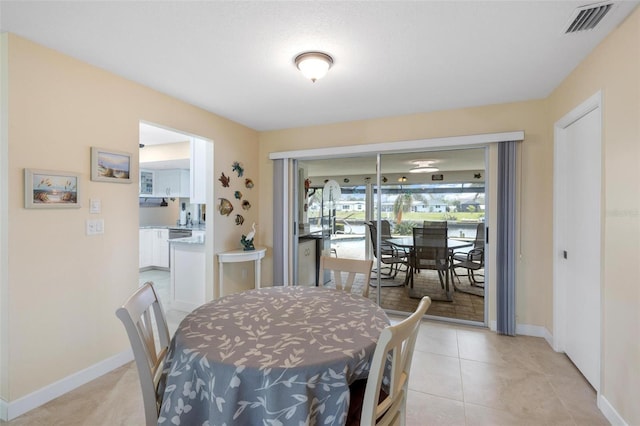 dining room with visible vents, baseboards, and light tile patterned flooring