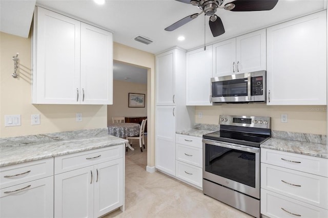 kitchen featuring visible vents, a ceiling fan, white cabinetry, appliances with stainless steel finishes, and light tile patterned floors