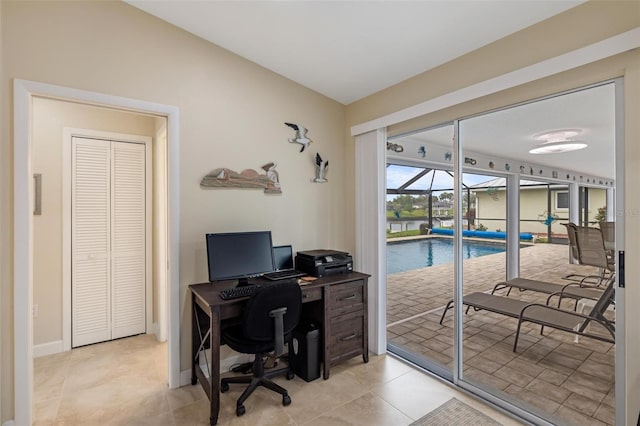 office with light tile patterned floors, baseboards, and a sunroom