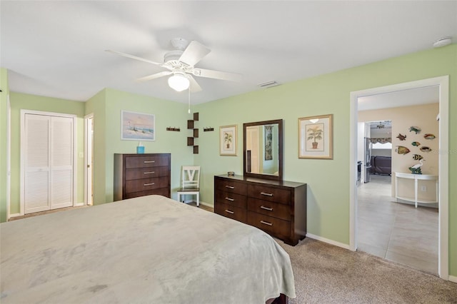 bedroom with baseboards, visible vents, carpet floors, ceiling fan, and a closet