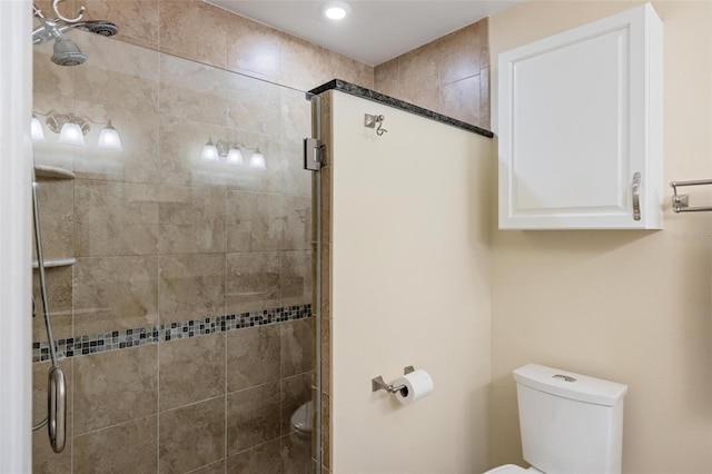 bathroom featuring a shower stall and toilet