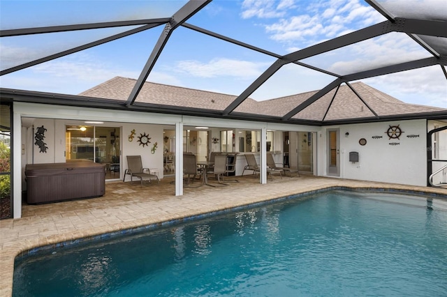 outdoor pool featuring a patio area, a lanai, and a hot tub