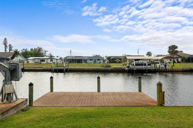 dock area featuring a yard, a residential view, and a water view