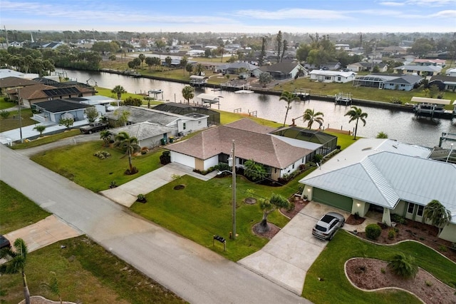 birds eye view of property featuring a residential view and a water view