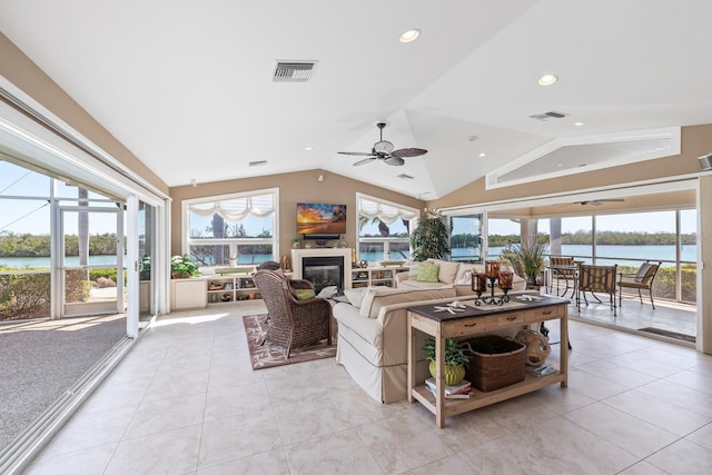 living room with lofted ceiling, a healthy amount of sunlight, and visible vents