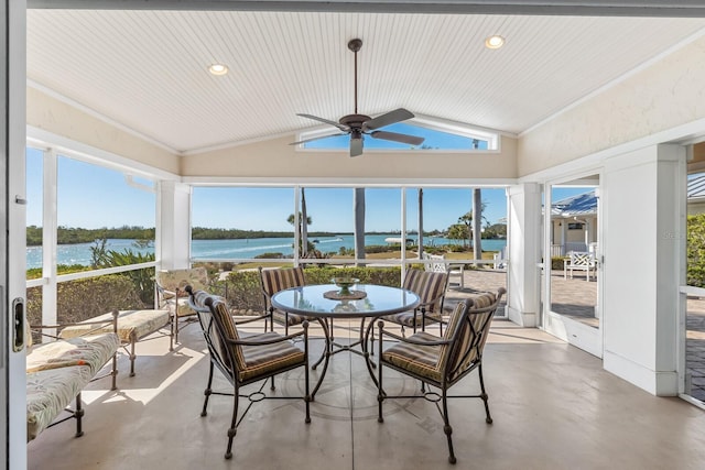 sunroom with a water view, plenty of natural light, ceiling fan, and vaulted ceiling