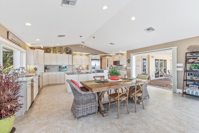 dining space featuring visible vents, lofted ceiling, and light tile patterned flooring