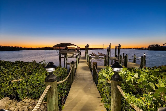 dock area with a water view and boat lift