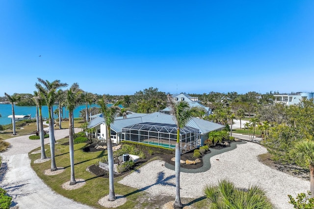 view of community with a water view and a lawn