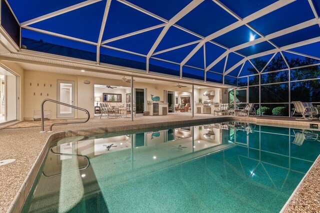 outdoor pool with a ceiling fan, a lanai, and a patio area