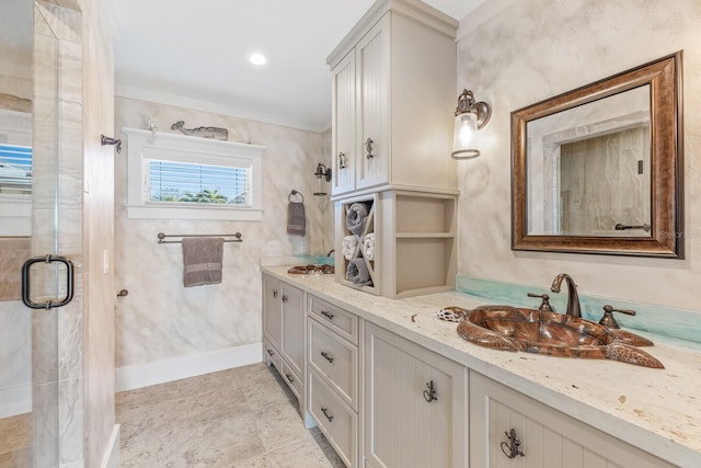 bathroom with a sink, baseboards, double vanity, and a shower stall