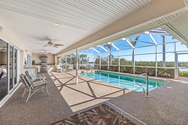 outdoor pool with a lanai, a patio, exterior kitchen, and ceiling fan