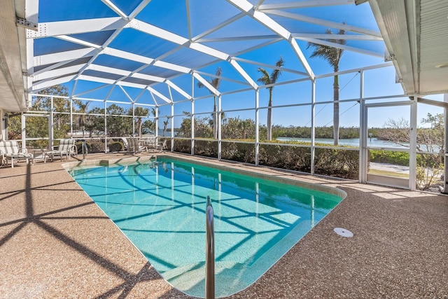 outdoor pool featuring a lanai, a patio area, and a water view