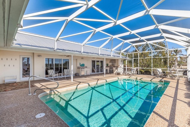 pool with a lanai, a patio area, and ceiling fan