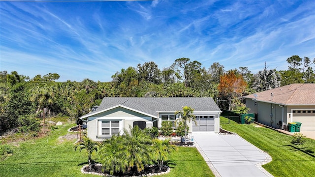 ranch-style house with a front yard, an attached garage, driveway, and stucco siding