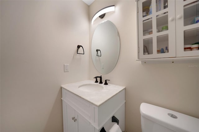 bathroom featuring toilet and vanity