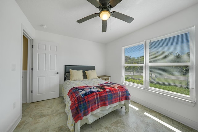 bedroom featuring baseboards and a ceiling fan