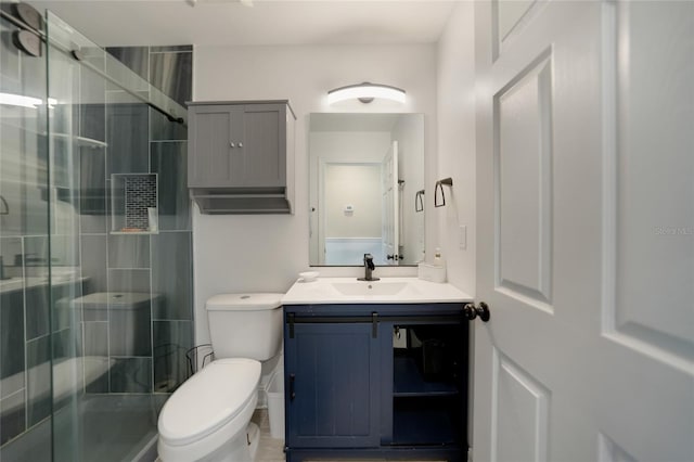 full bath featuring vanity, toilet, and a shower stall