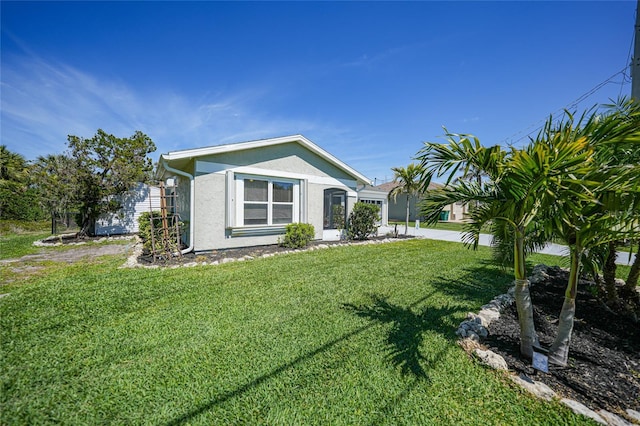 exterior space with a lawn and stucco siding