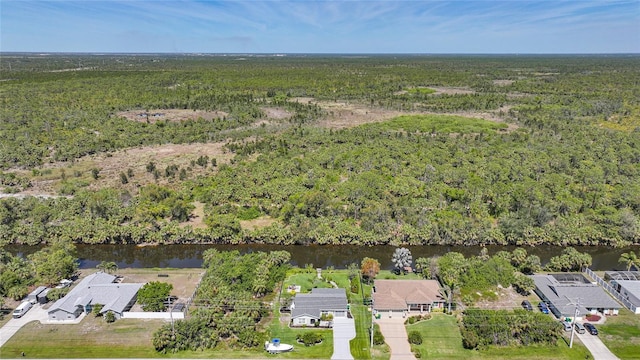 aerial view featuring a view of trees and a water view