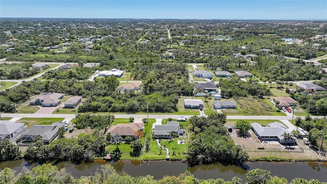 drone / aerial view with a residential view and a water view