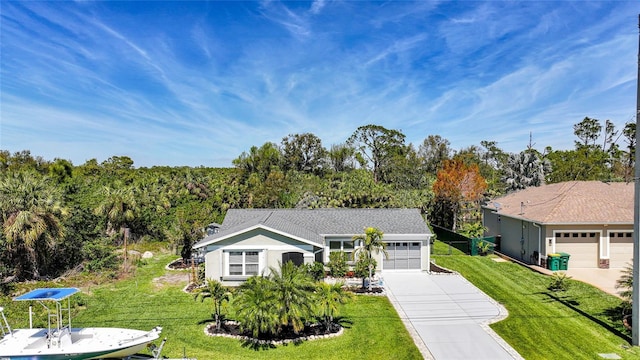 view of front facade with a front lawn, a garage, and driveway