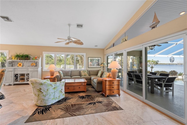 living area with vaulted ceiling, a healthy amount of sunlight, and visible vents