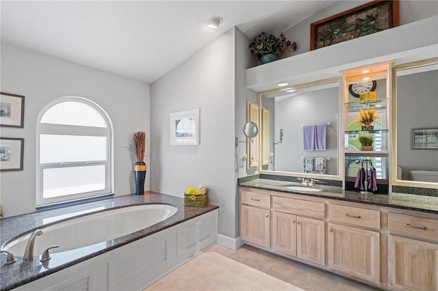 full bath featuring toilet, tile patterned flooring, a bath, vanity, and vaulted ceiling