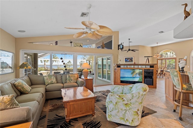 living room featuring visible vents, ceiling fan, and stone finish flooring