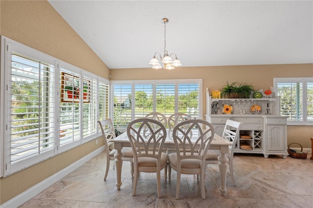 dining room featuring a chandelier, baseboards, and lofted ceiling