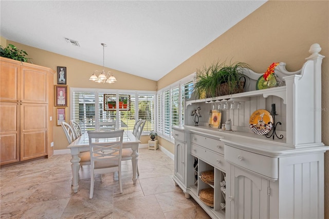 dining space with a chandelier, visible vents, baseboards, and lofted ceiling