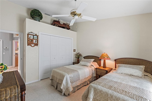 bedroom with baseboards, visible vents, ceiling fan, a closet, and light colored carpet