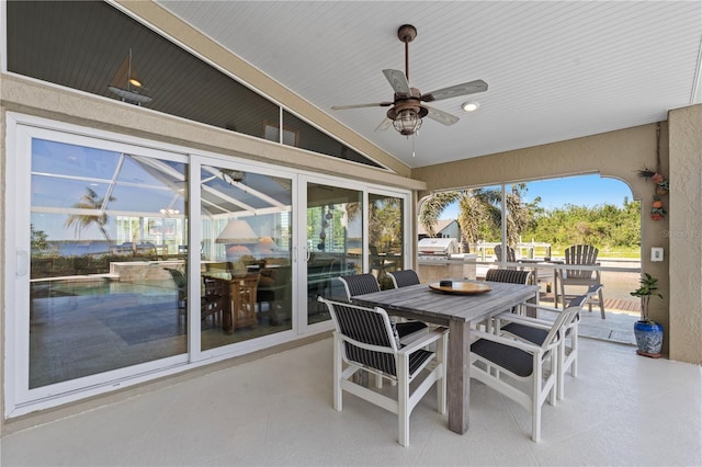 exterior space with outdoor dining area, grilling area, and a ceiling fan