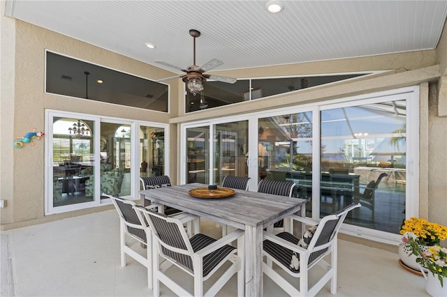 sunroom featuring ceiling fan