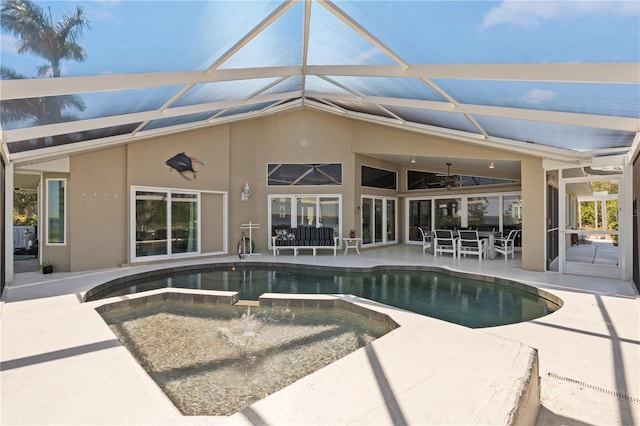 view of pool with a pool with connected hot tub, ceiling fan, a lanai, outdoor dining space, and a patio