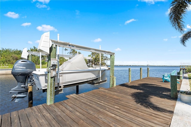 view of dock with boat lift and a water view