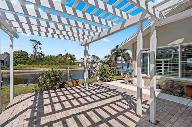 view of patio / terrace with a pergola and a water view