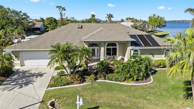 view of front facade with a shingled roof, a front lawn, concrete driveway, stucco siding, and a garage