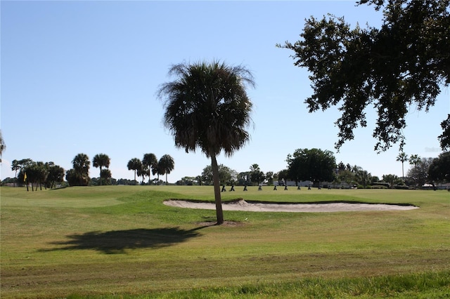 surrounding community with a lawn and golf course view