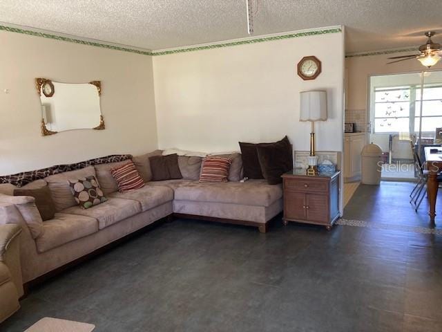 living room featuring a textured ceiling and ceiling fan