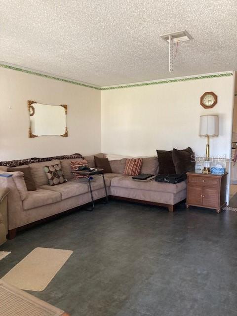 living room with concrete flooring and a textured ceiling