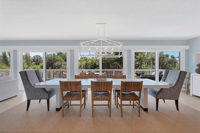 dining space with a notable chandelier and a textured ceiling