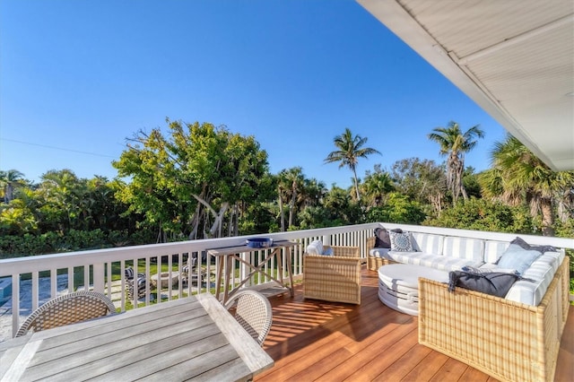 wooden deck with outdoor dining space and an outdoor living space